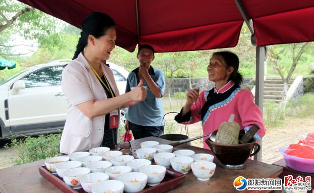 在丹口鎮(zhèn)桃林村，村民們?yōu)橘F客打油茶，香醇的油茶讓游客豎起了大拇指。